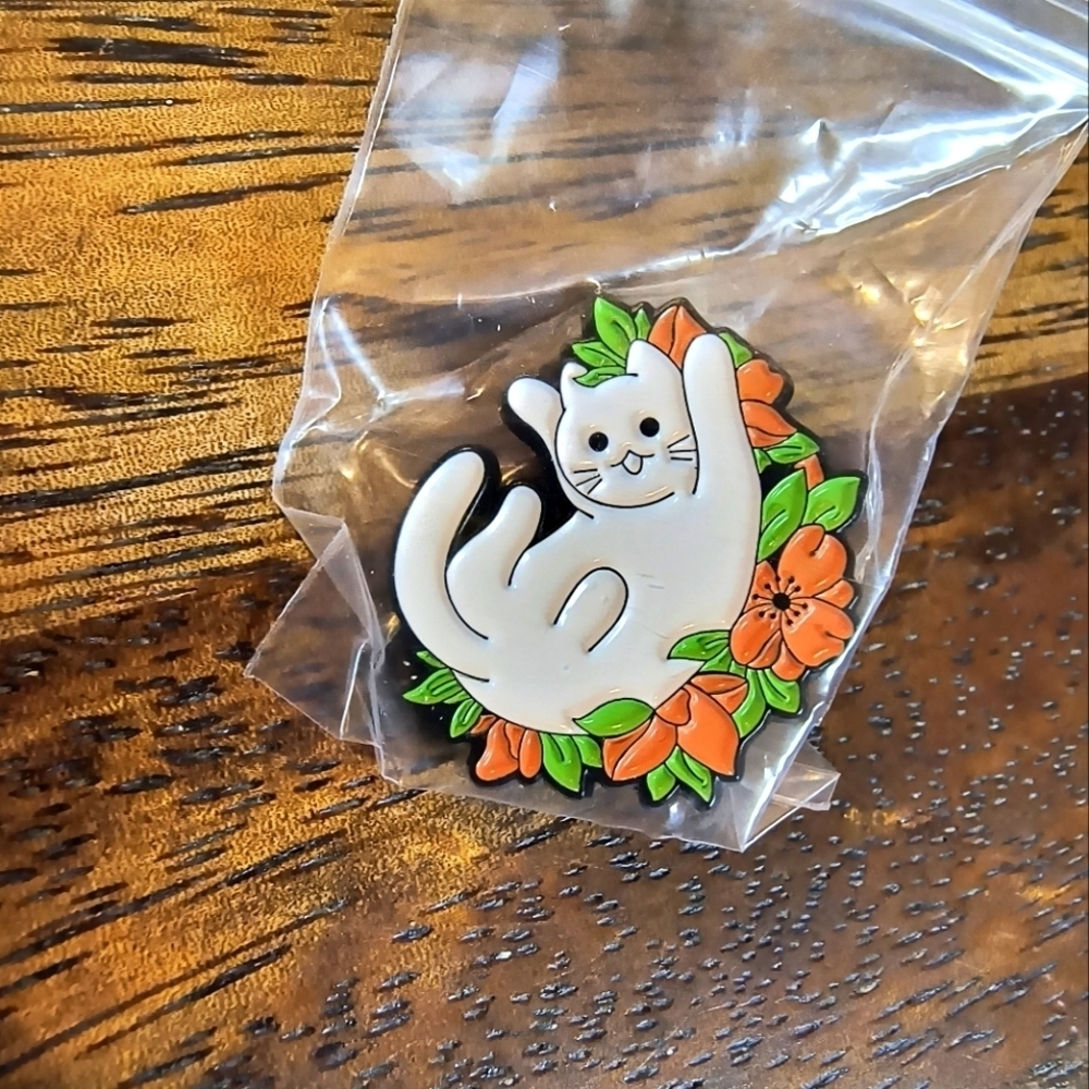 White cartoon cat in green leaves orange flowers pin backpack clothes hat bag